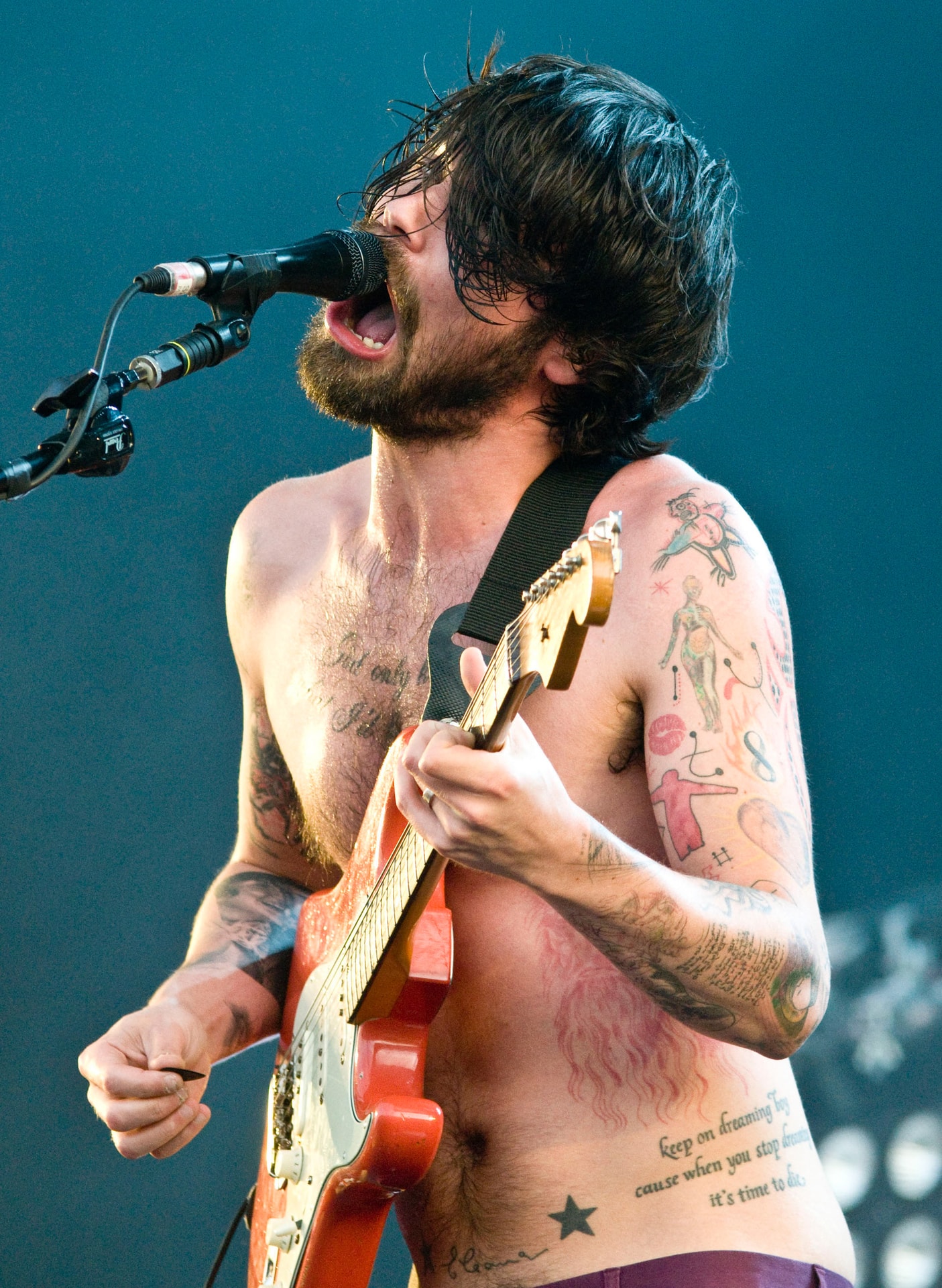 Biffy Clyro performing live with an electric guitar and microphone