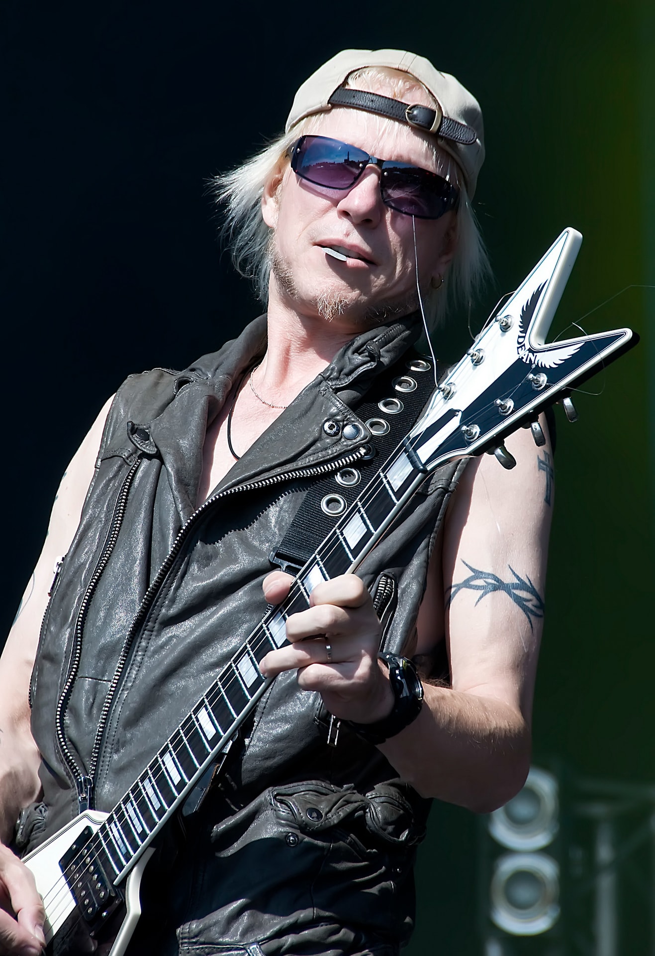 Michael Schenker playing a Flying V electric guitar on stage